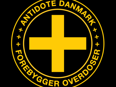 Antidote Danmarks logo - et gult kryds med to cirkler omkring