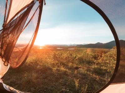 Udsigt over smukt landskab fra åbningen af et telt