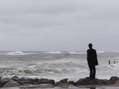A man standing alone on the sea shore_Photo by: Eexistentialcrisiss